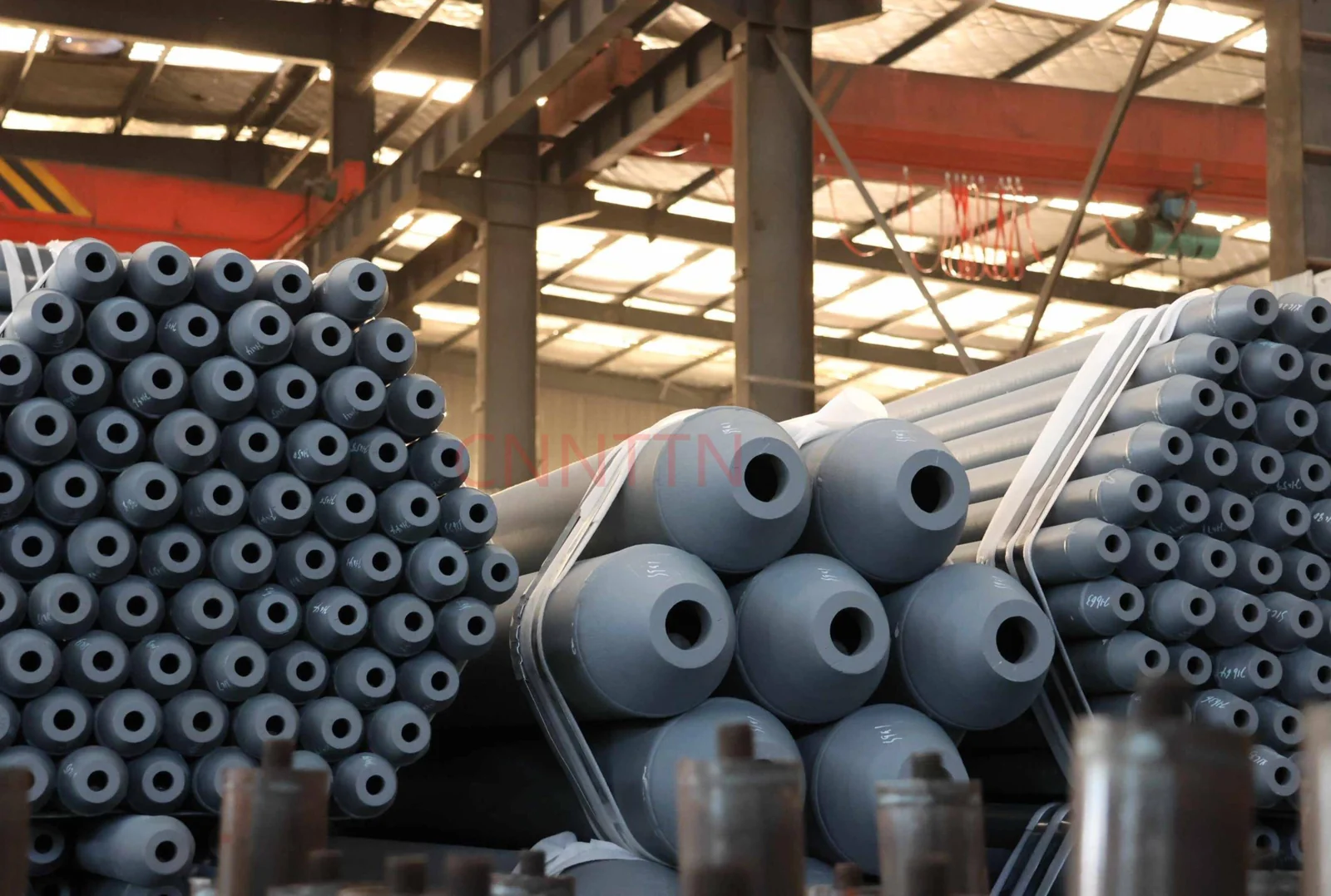 Fabricated members arranged in a workshop.