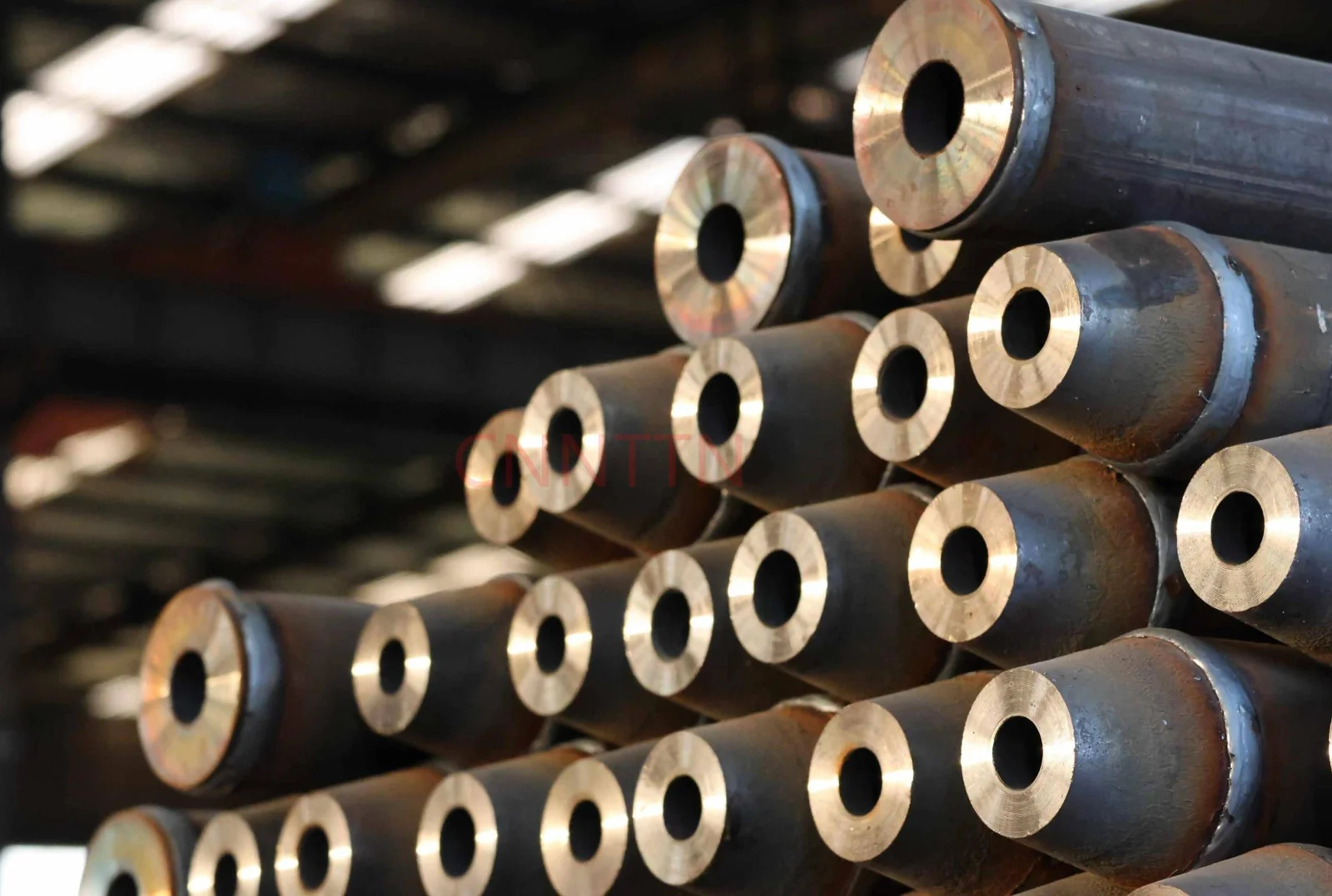 A group of fabricated tubular members in a workshop.