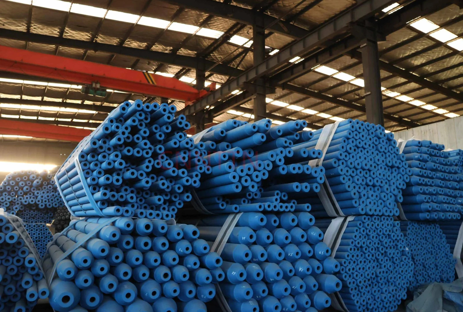 Bundles of painted structural members.