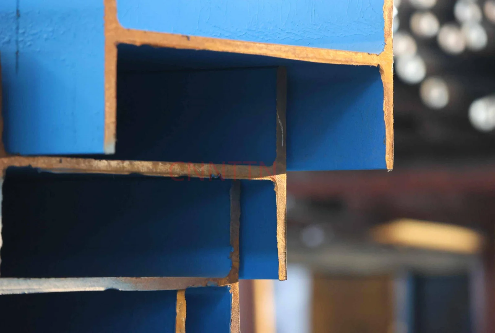 Open steel sections shown in a workshop.