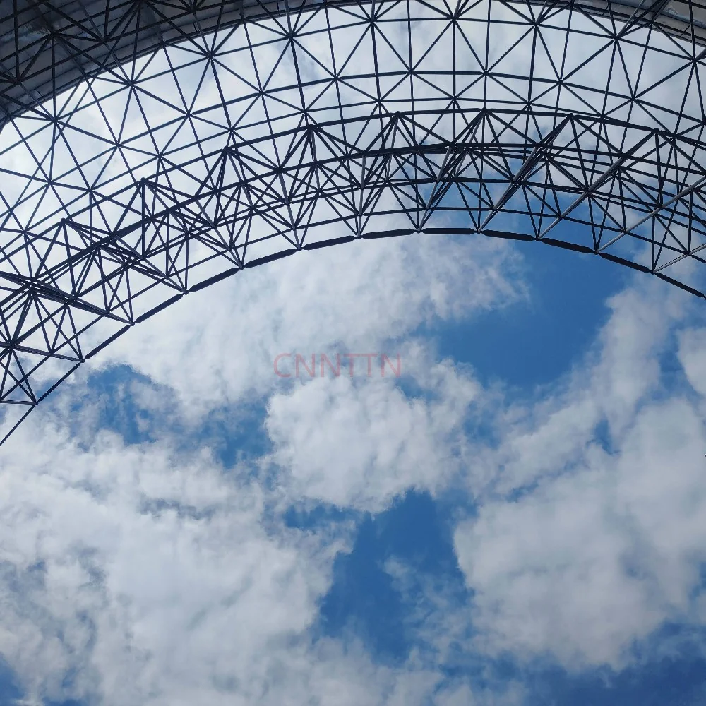 Curved lattice structure against the sky. Image from the supplied site archive; project identity is not documented here.